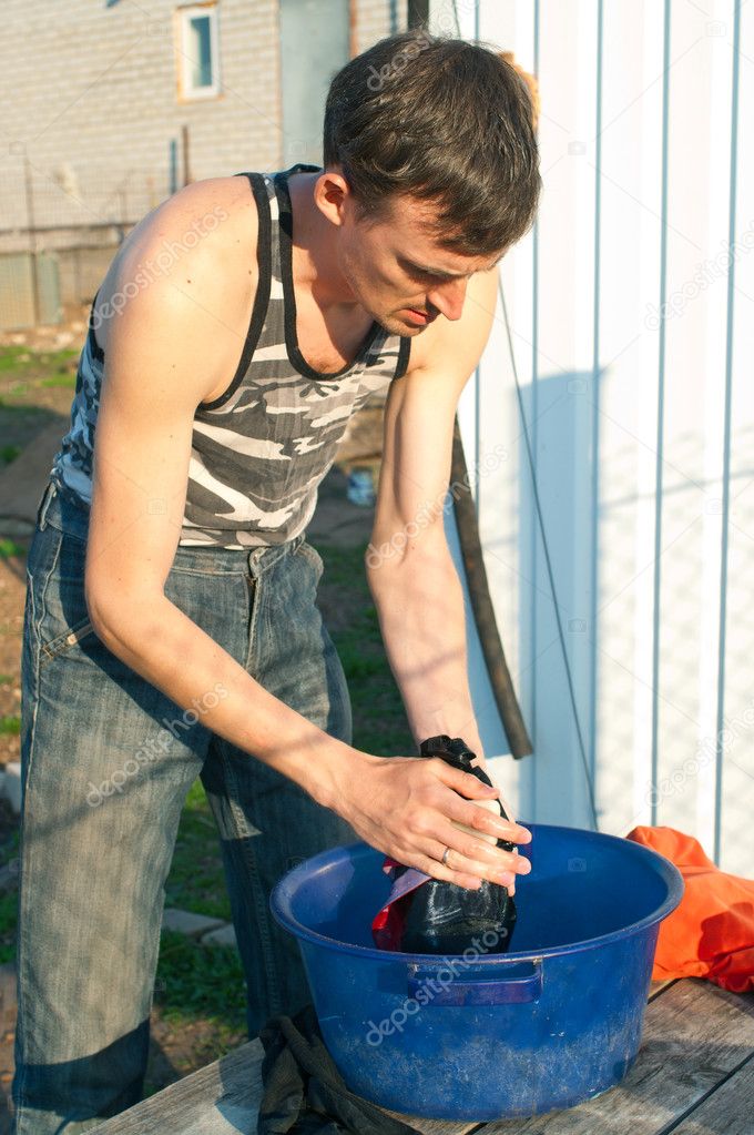 Man hands washes clothes