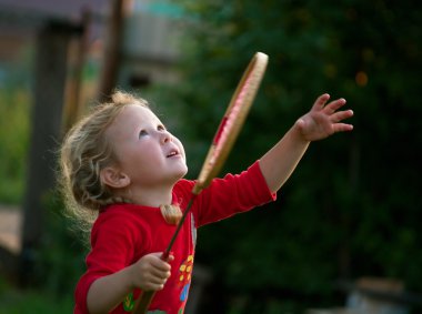 Girl plays with a racket in badminton clipart