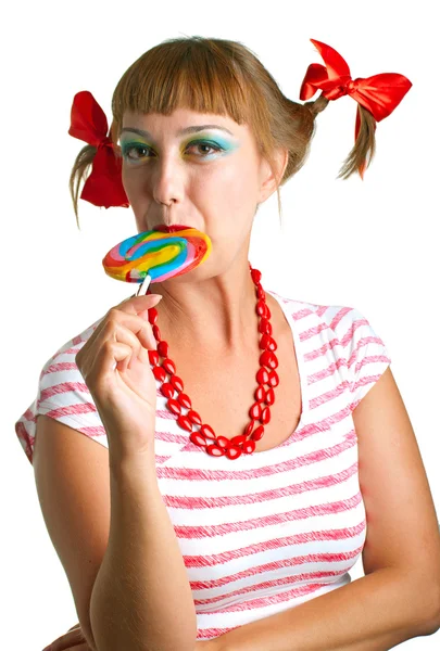 Girl with plaits biting a lollipop — Stock Photo, Image