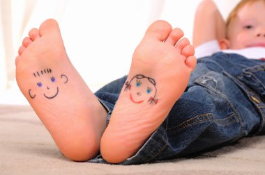 Small faces painted on the soles clipart