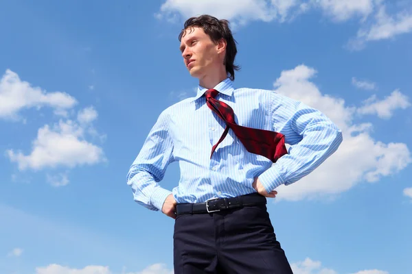 Young business man in a blue shirt and red tie — Stock Photo, Image