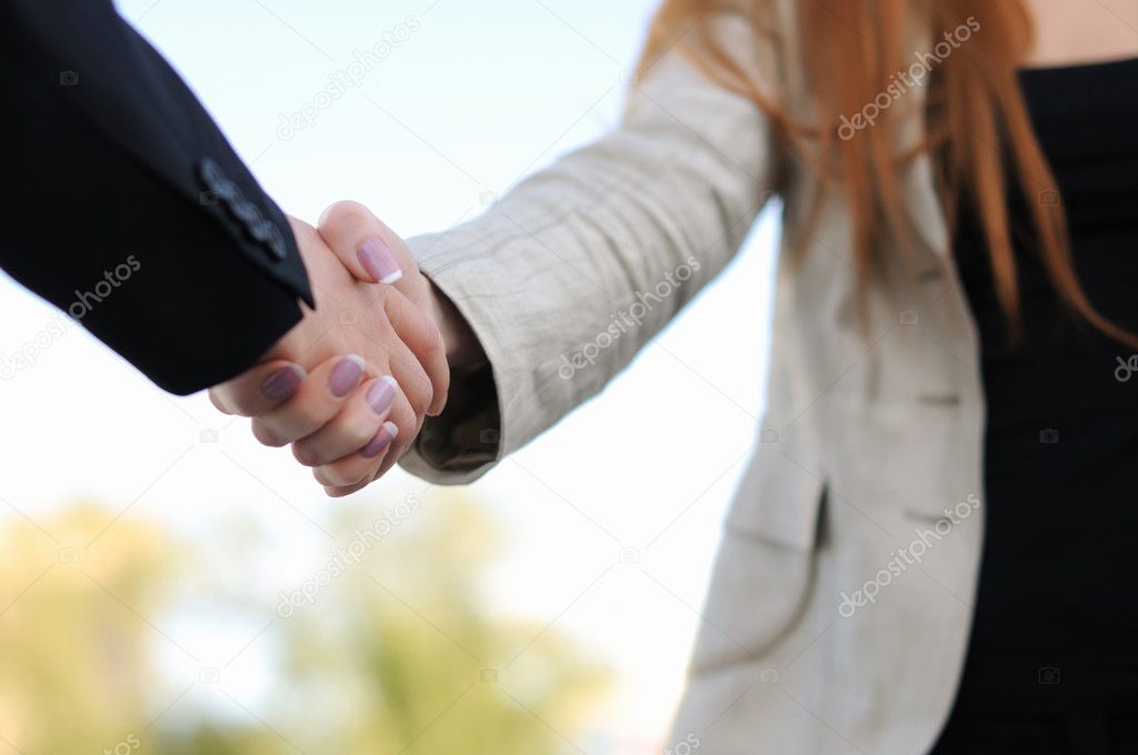 Shaking hands on a light background