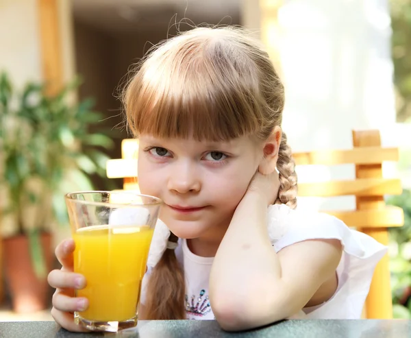 Portrait of little girl with orange juice Stock Image
