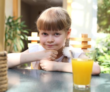 Portrait of little girl with orange juice clipart