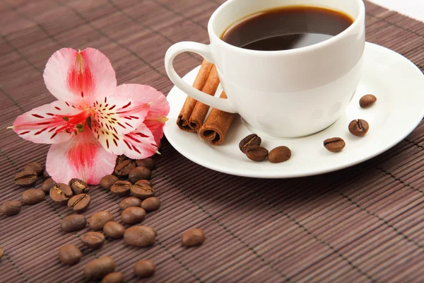 stock image Cup of coffee with tubes of cinnamon