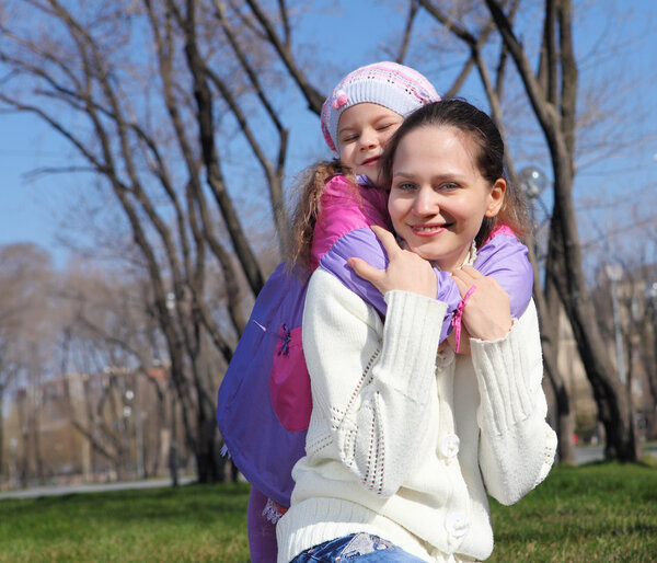 Little girl with mother in spring park