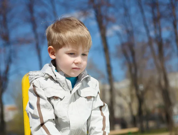 Young boy walks in the park — Stock Photo, Image