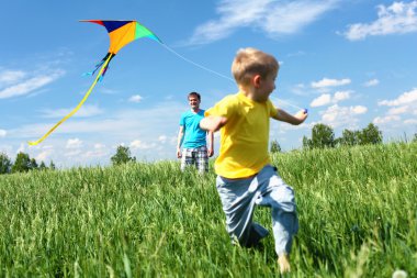 Father with son in summer with kite clipart