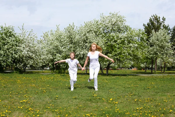 Chica con madre en el parque de primavera — Foto de Stock