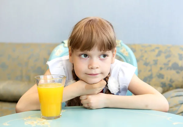 Portrait of little girl with orange juice — Stock Photo, Image