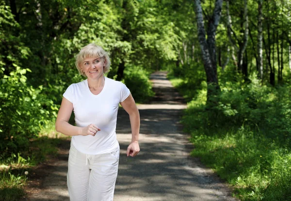 stock image Elderly woman likes to run in the park