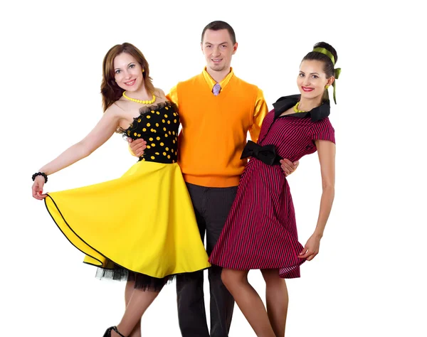Young man with two women in bright colour wear — Stock Photo, Image