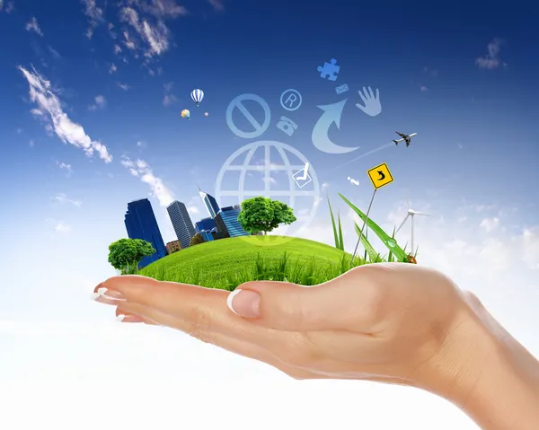 Human hand holding a green city — Stock Photo, Image