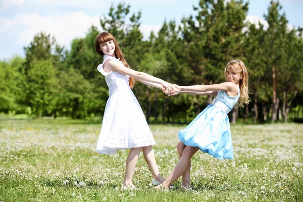 Two girls playing in the park Royalty Free Stock Photos