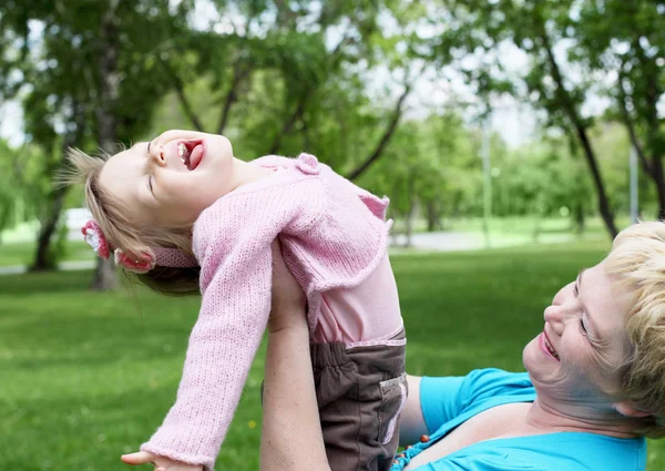 Grandmother with her granddaughter outdoors — Stock Photo, Image