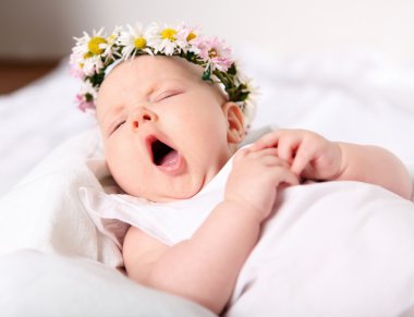 Portrait of a yawning baby girl clipart
