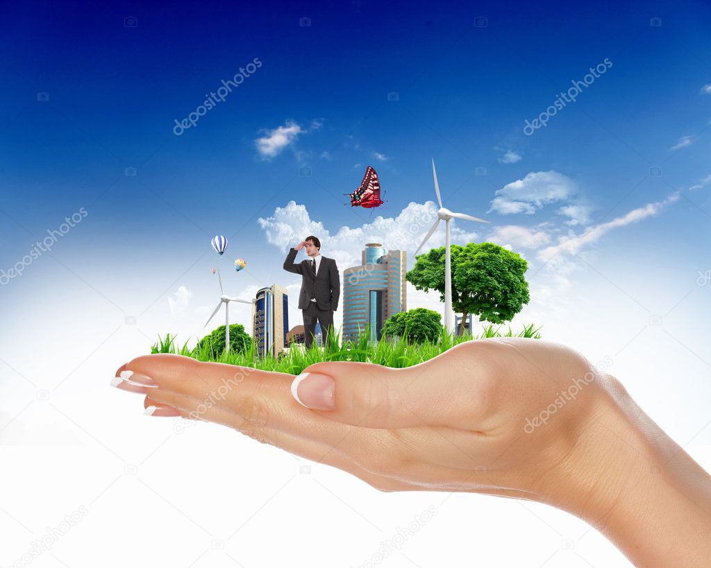 Human hand holding a green city