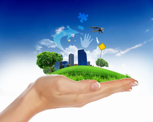 Human hand holding a green city — Stock Photo, Image