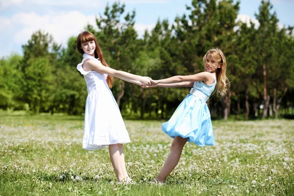 Two girls playing in the park Stock Photo