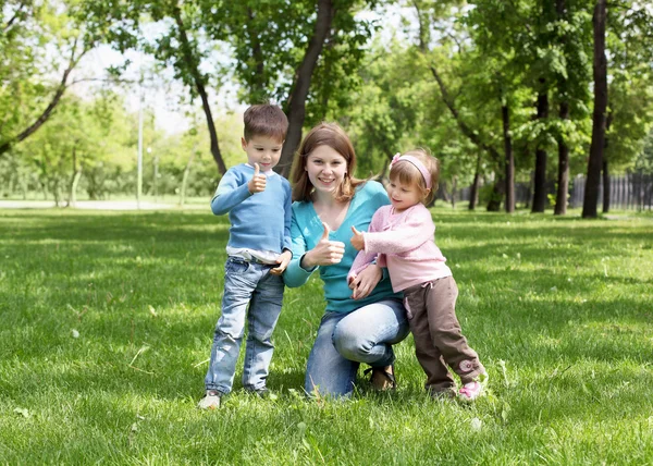 Portrait of mother and children in the park — Stock Photo, Image