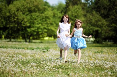 Two girls playing in the park clipart