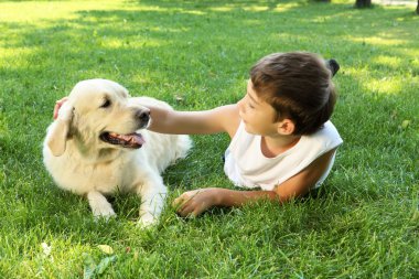 Tennager boy in the park with a dog clipart