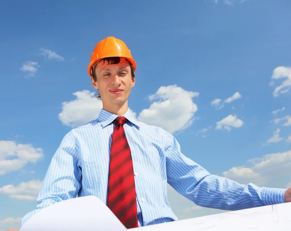 Young engineer in a blue shirt and yellow helmet — Stock Photo, Image