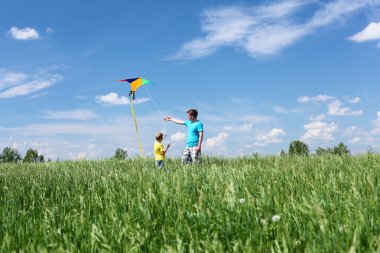 Father with son in summer with kite clipart