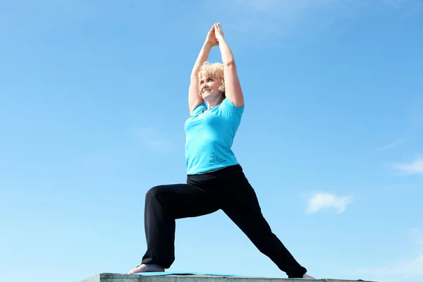 Portrait of a senior woman doing yoga — Stock Photo, Image