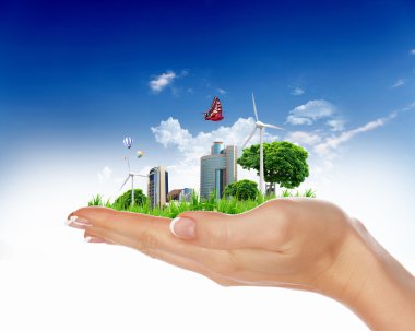 Human hand holding a green city clipart