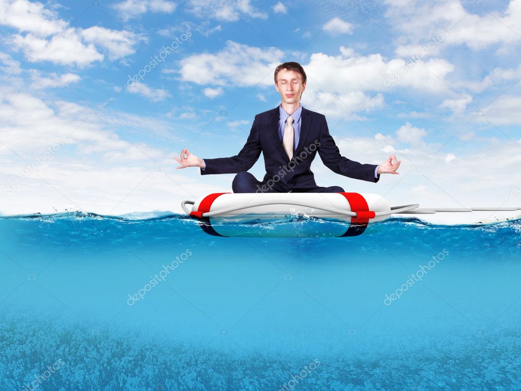 Businessman meditating on the rescue ring