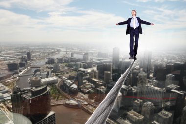 Business man balancing on the rope clipart
