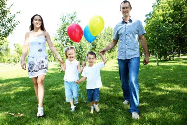 Family with two children in the summer park