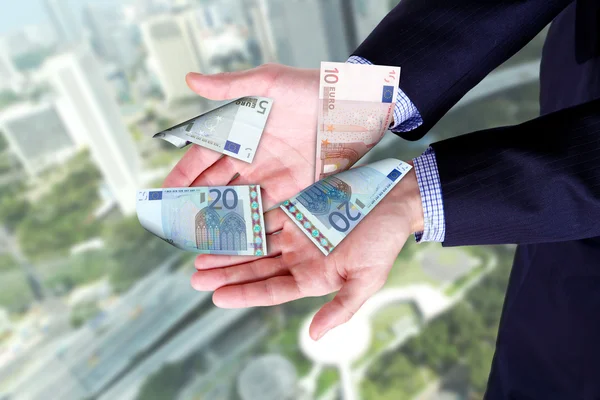 Panoráma města a ruce držící bankovky — Stock fotografie