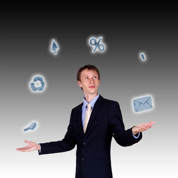 Business man juggling with numbers and symbols — Stock Photo, Image