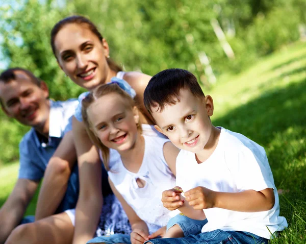 Rodina se dvěma dětmi v letním parku — Stock fotografie