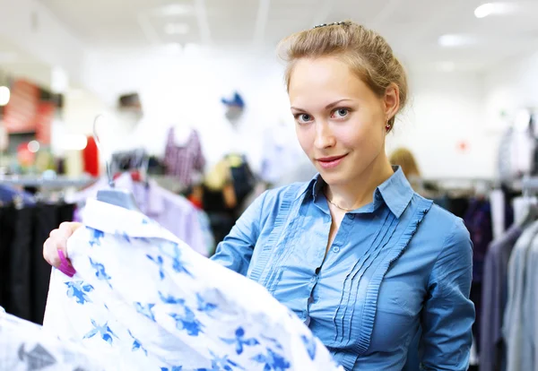 Woman in a shop buying clothes Stock Picture