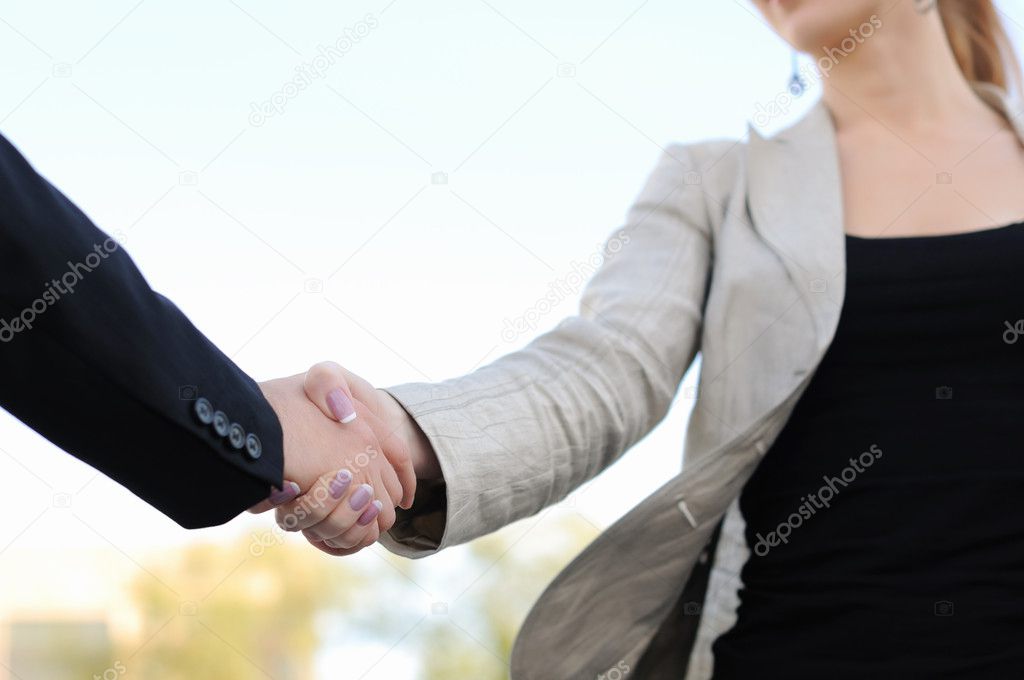 Shaking hands on a light background