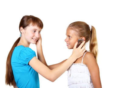 Pretty teenage girls with mobile phone clipart