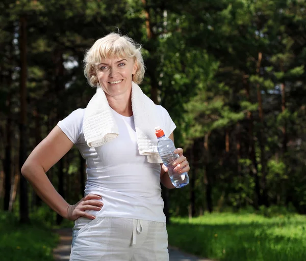 stock image Elderly woman after exercising in the forest