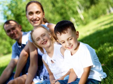 Family with two children in the summer park