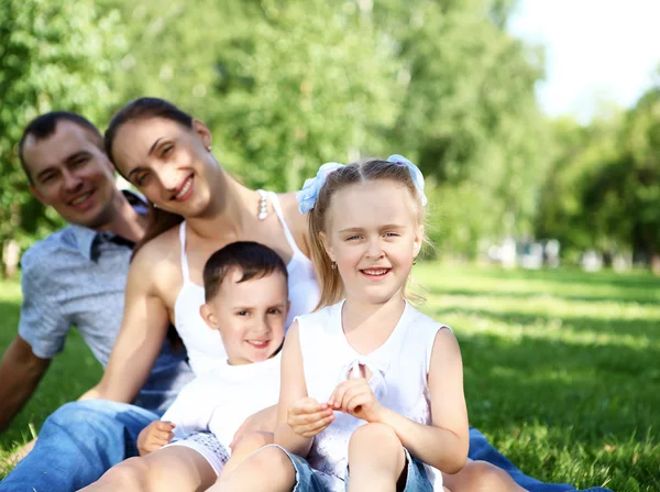 Сім'я з двома дітьми в літньому парку — стокове фото