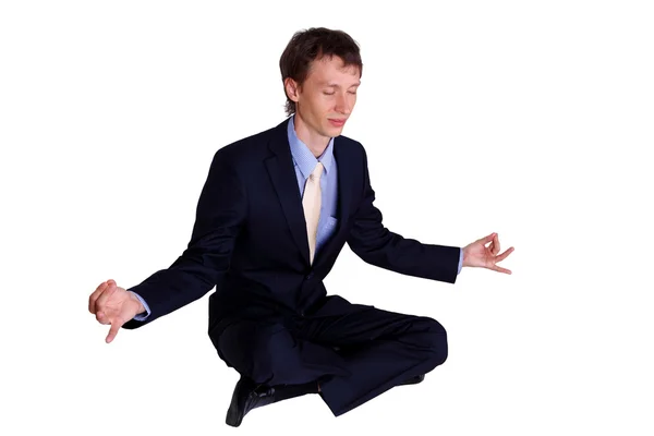 Business man in studio meditating — Stock Photo, Image