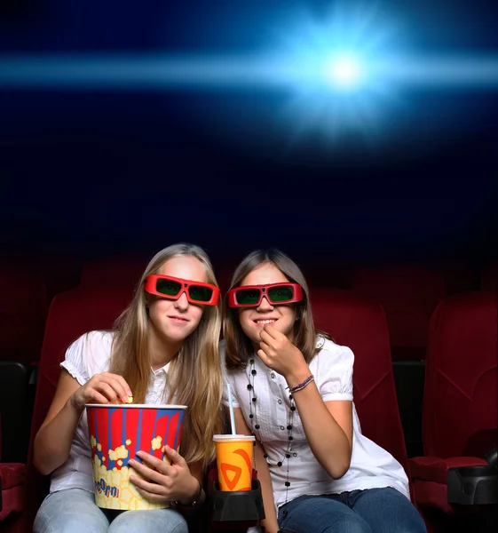 Two young girls in cinema — Stock Photo, Image