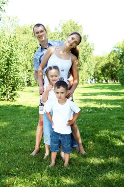 Family with two children in the summer park