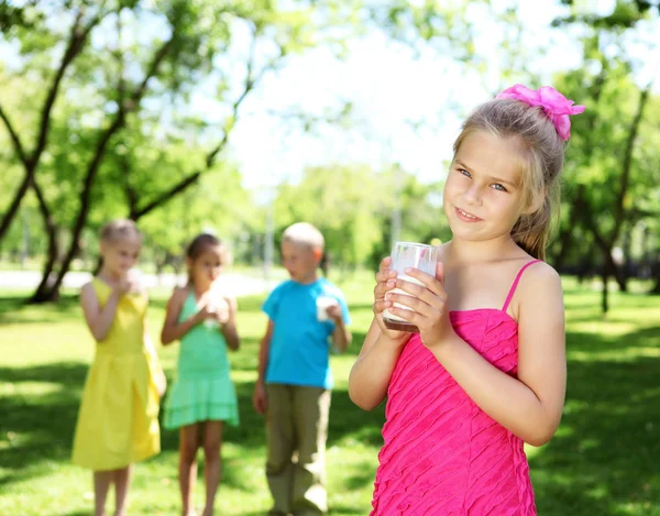 女孩喝的牛奶中夏公园 — 图库照片