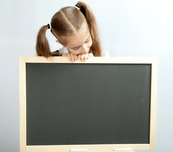Girl and clear blackboard — Stock Photo, Image
