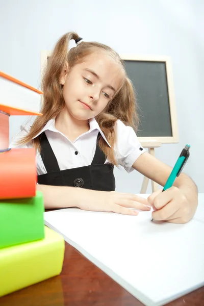 School girl sitting at the table with books. — Stock Photo, Image