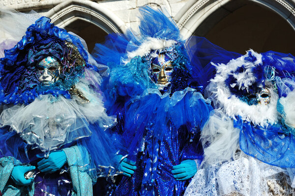 3 masks dressed in blue costumes ,Venice carnival