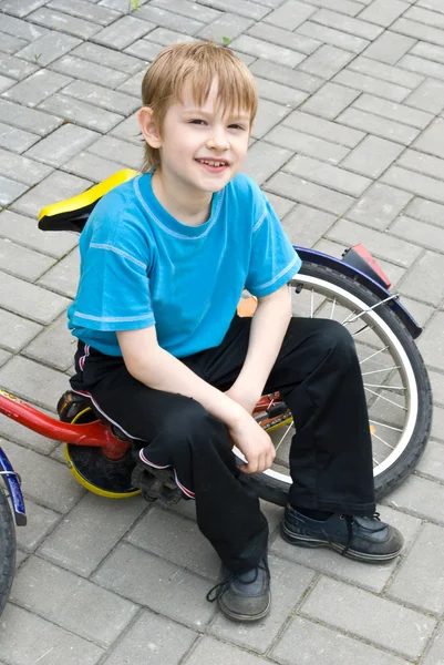 stock image Boy sits on bicycle